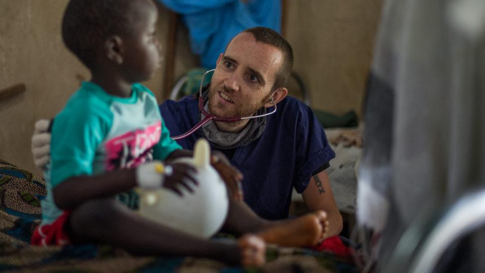 Dr. Matt checking on a young patient in the children's ward at St. Theresa Hospital