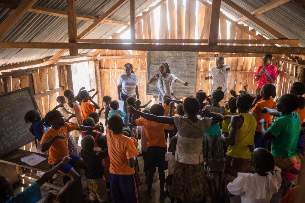 Catherine in a classroom with community children