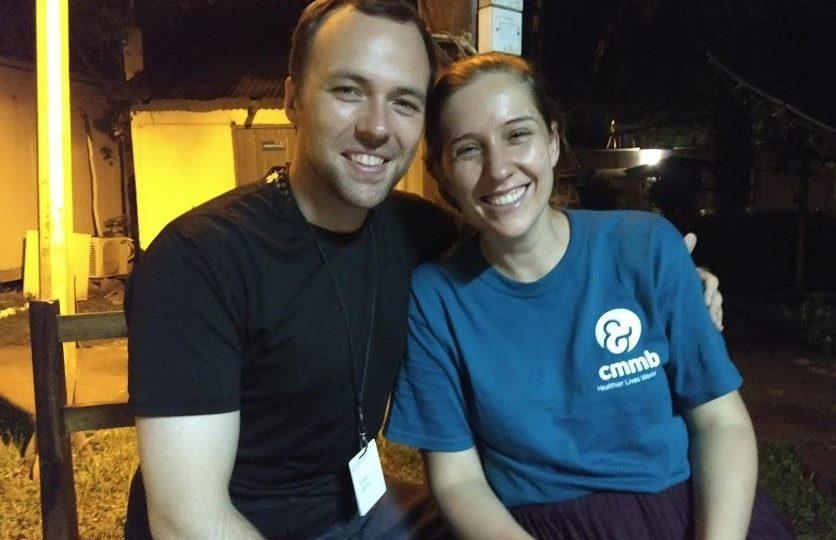 Dan and Angela sit together outside after the sun has set