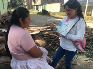 Gina teacing a community mother about hanwashing practices 