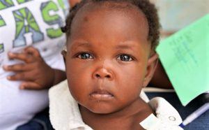 A young girl from Haiti staring straight into the camera.