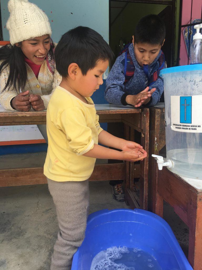 A little boy in Peru practices handwashing! 