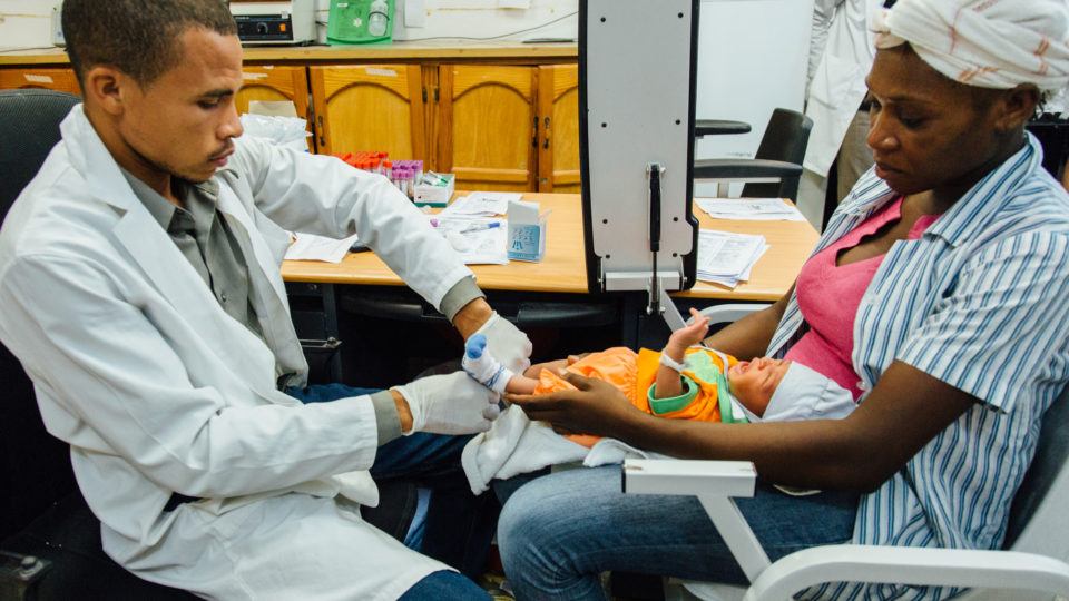 health worker taking blood from mom