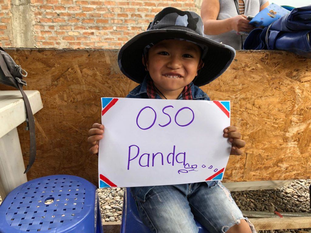a young boy shares that panda's make him happy. He writes his response on a piece of paper 