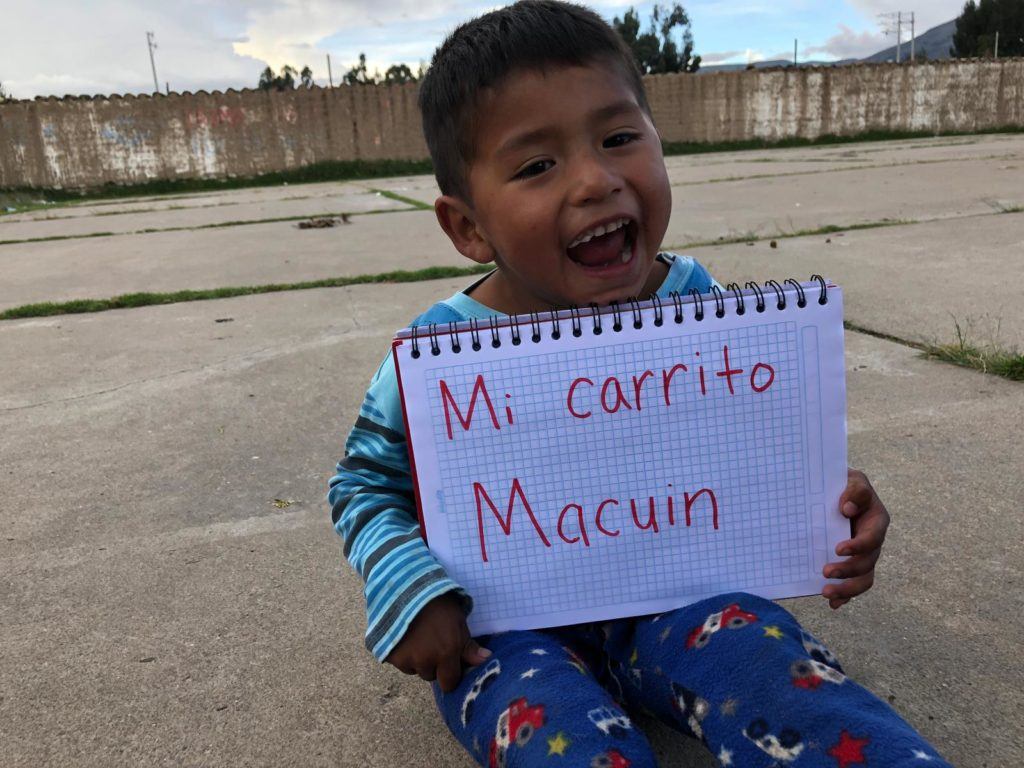 little boy from Peru shares what makes him happy. He writes his response on a piece of paper 