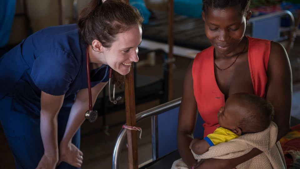 Sarah Rubino is speaking with a young patient and his mother