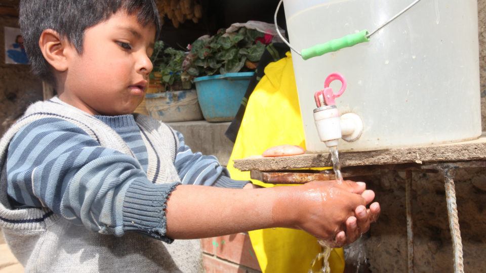 Little boy in Peru washing his hands