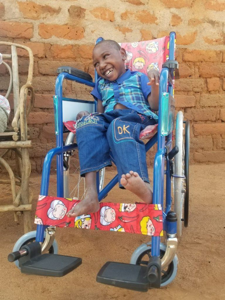 Amos and his wheelchair the day it was delivered