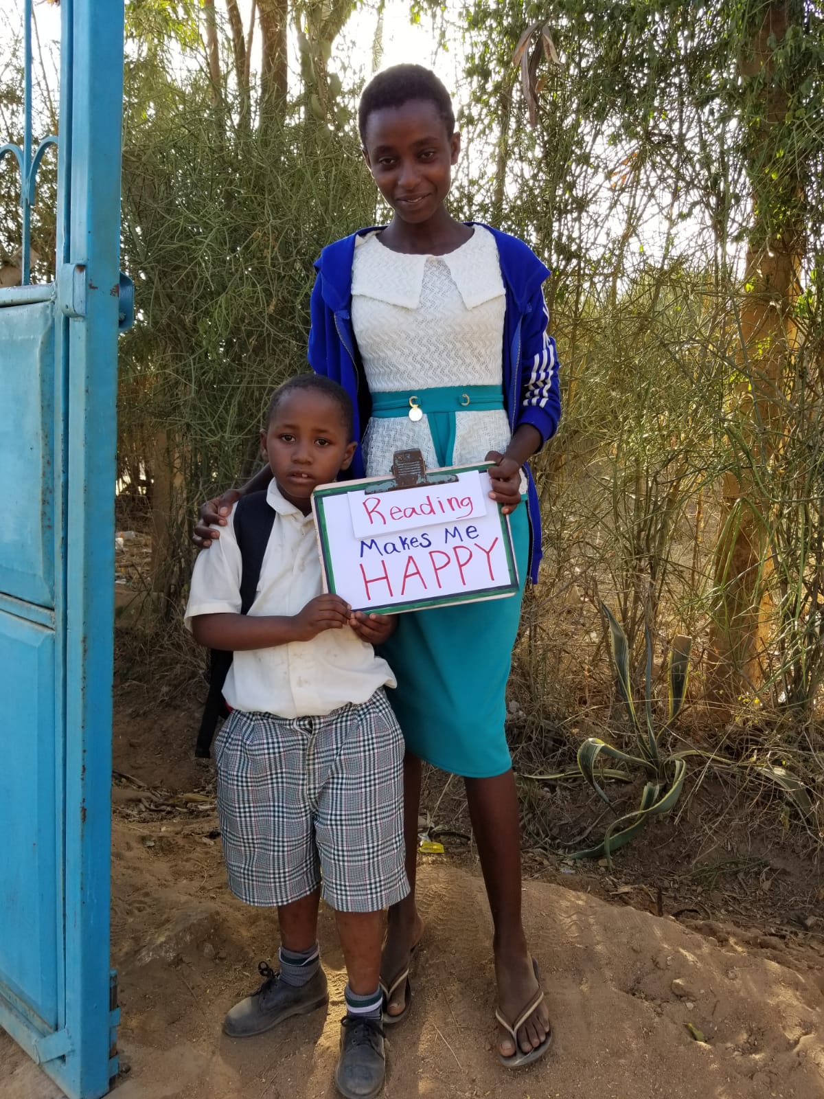 Child and mother in Kenya with sign