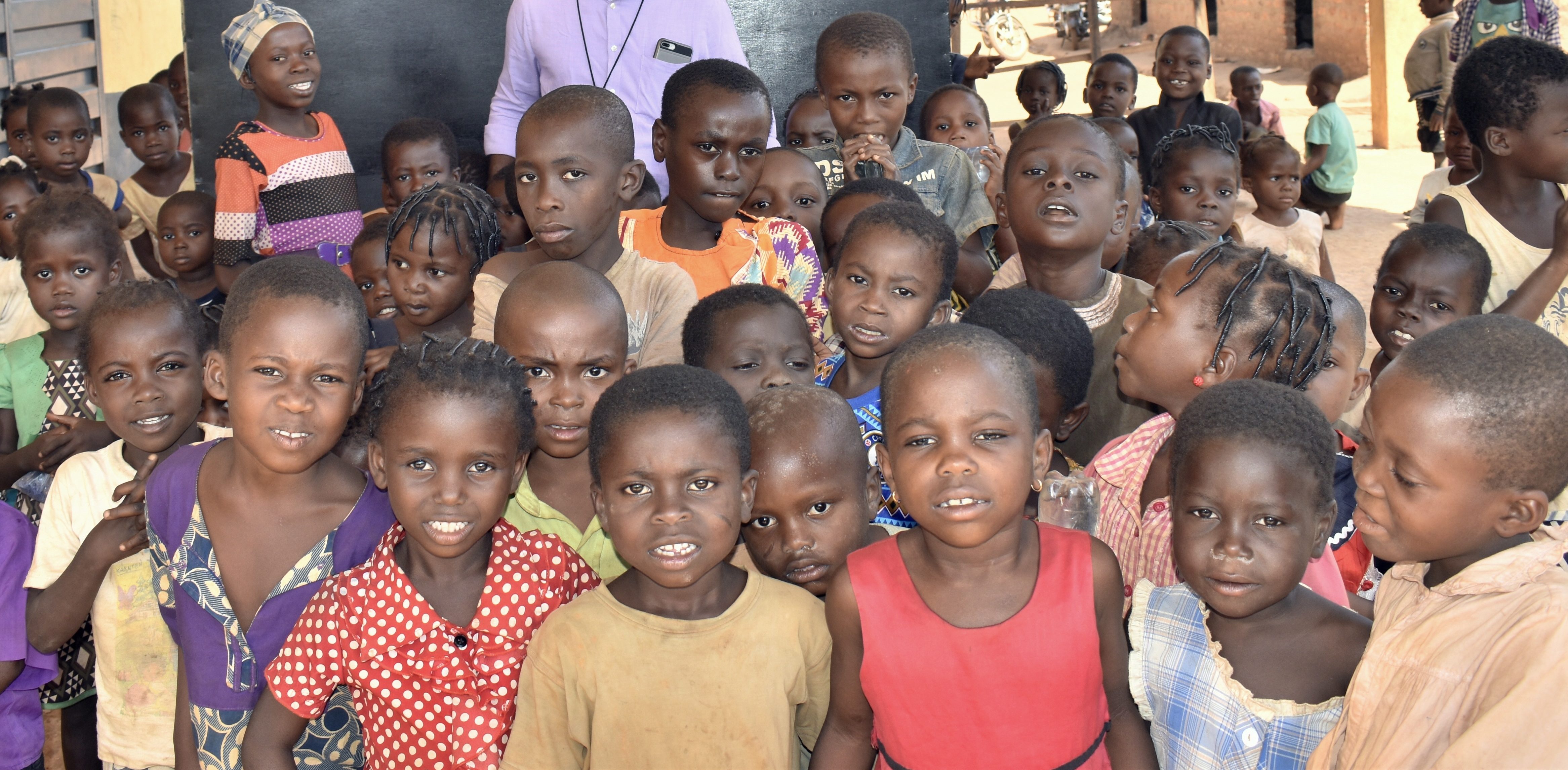 children in front of black board at refugee camp cameroon