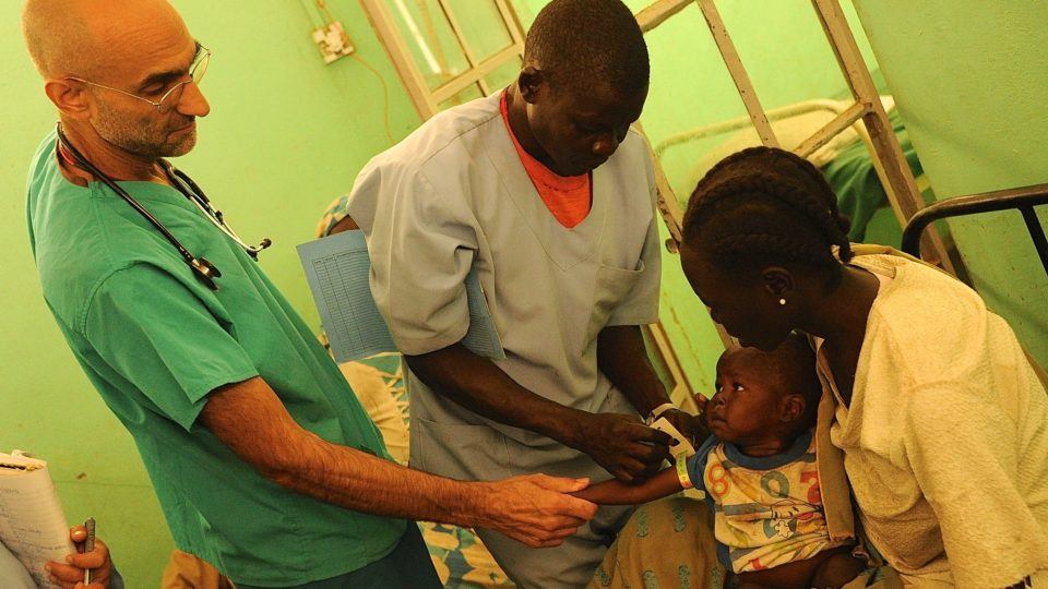 Dr. Tom treats a baby at the mother of mercy hospital in sudan.