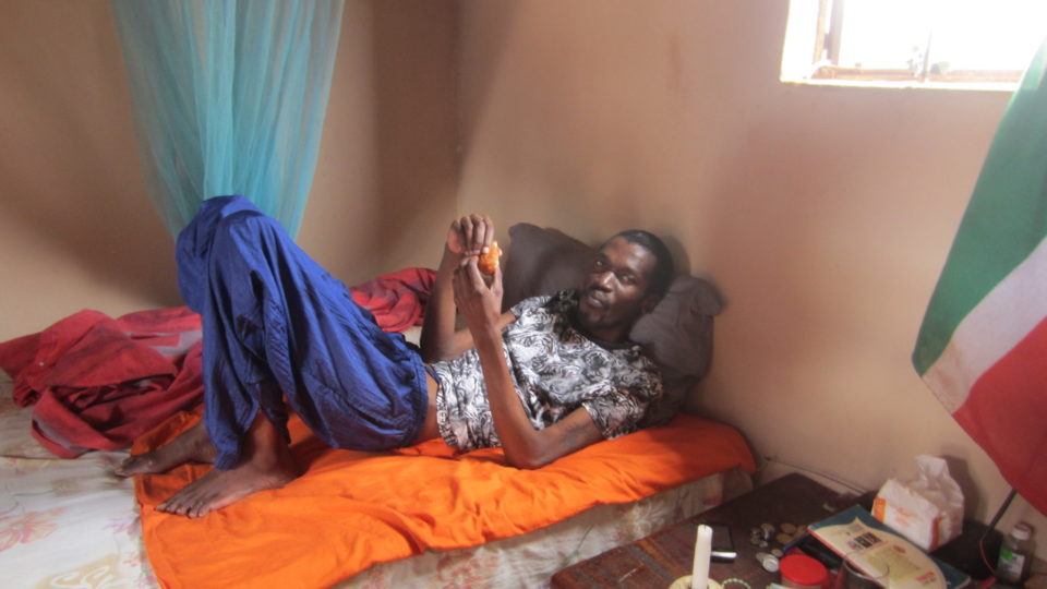 Khulani at his home, laying in bed