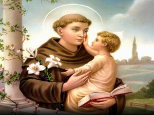 Saint anthony of padua represented in a painting holding a young child 