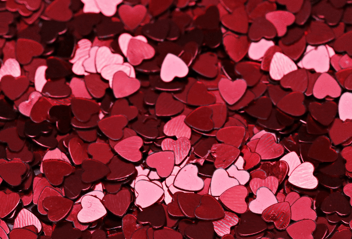 Pink and red heart cut outs piled on top of one another 