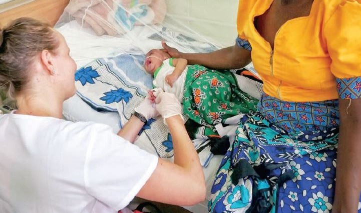 Joanna serving a newborn patient in Kenya