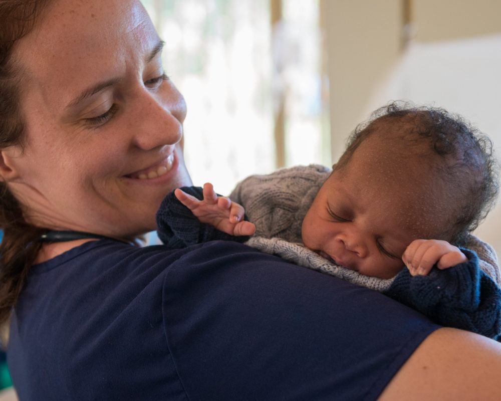 Sarah Rubino holds a newborn baby in Nzara South Sudan