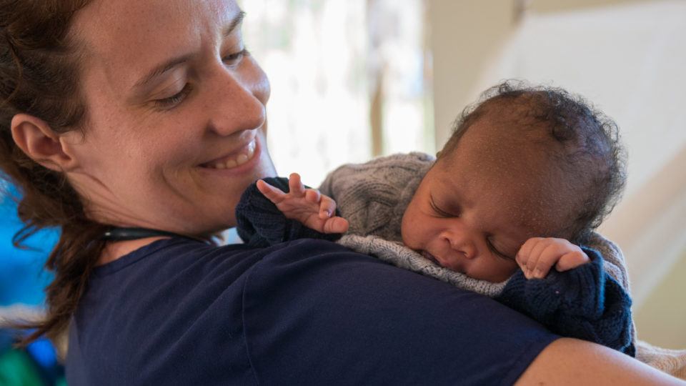 Sarah Rubino holds a newborn baby in Nzara South Sudan