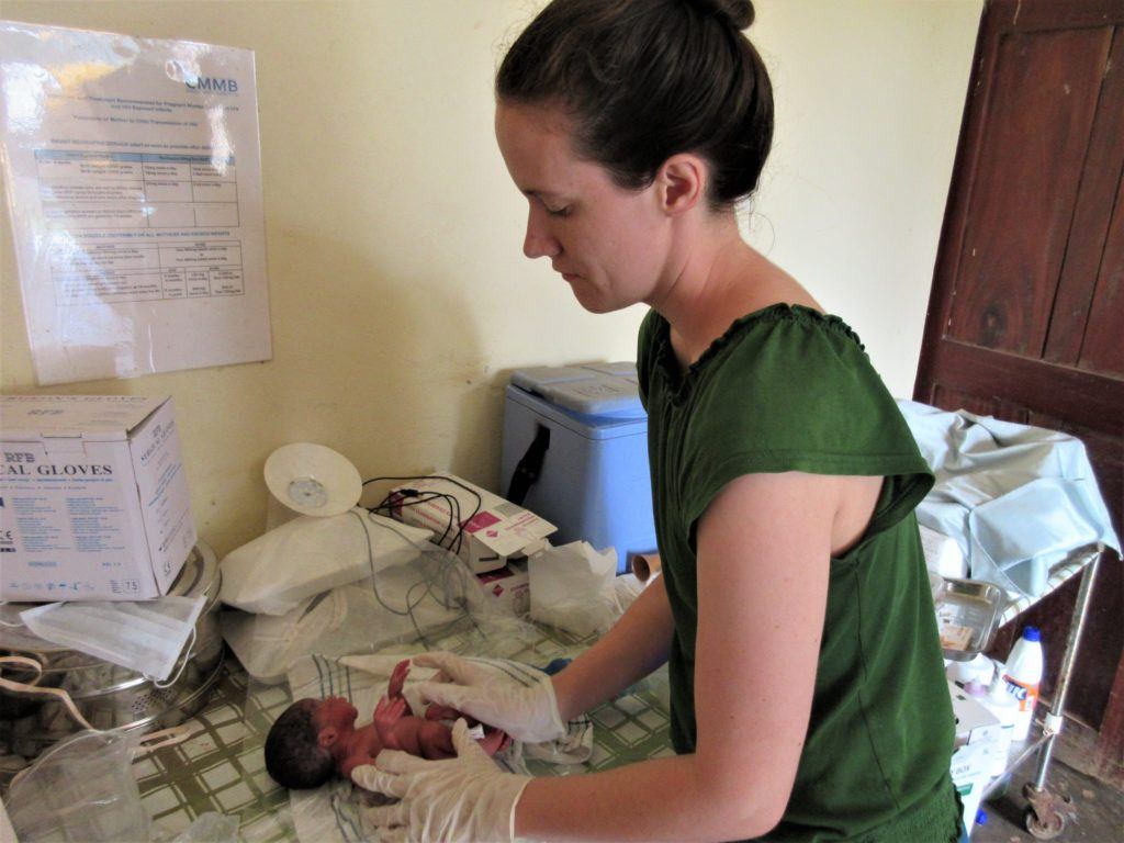 Sarah caring carefully for a young premature baby in Nzara, South Sudan