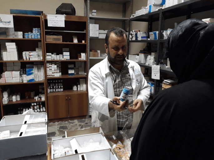 woman receiving drugs from free pharmacy