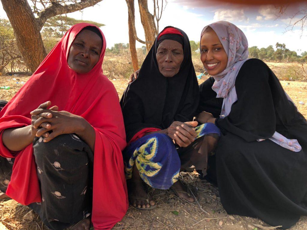 Three women wearing head scarfs. Asha, far right, is a St. Kate's student who is completing her practicum with our team in Kenya.