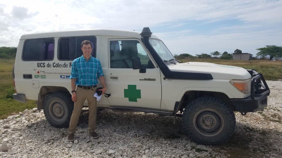 Dr. Zach stands in front of an ambulance in Haiti