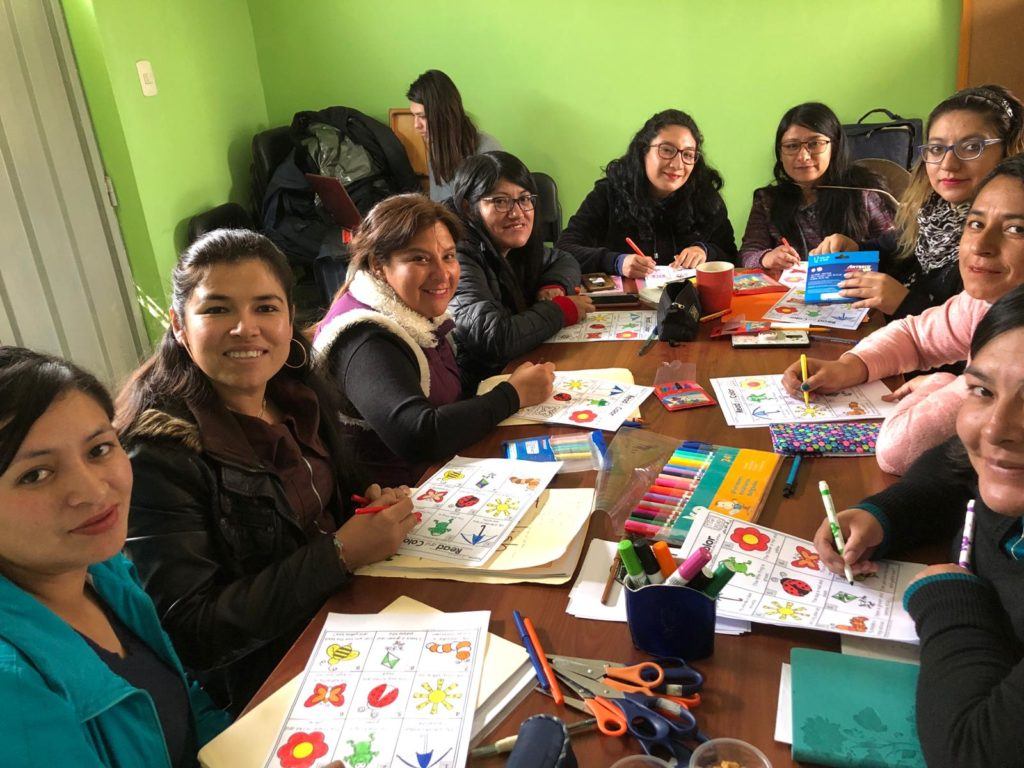 Peruvian women sitting around a table for English class