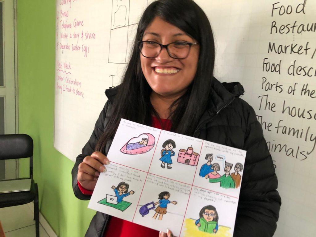 Nataly, a mother in English Class, believes the class will help her in her future. She holds an image she created narrating an english story. 