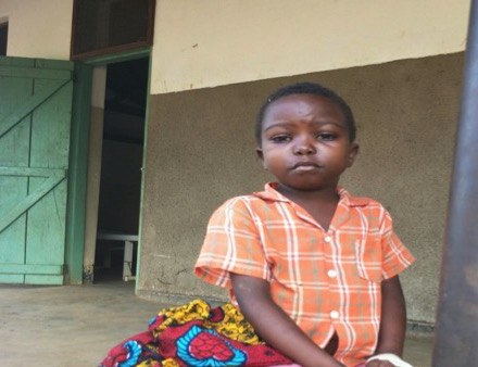 Pasqual sits outside the hospital in Nzara, South Sudan