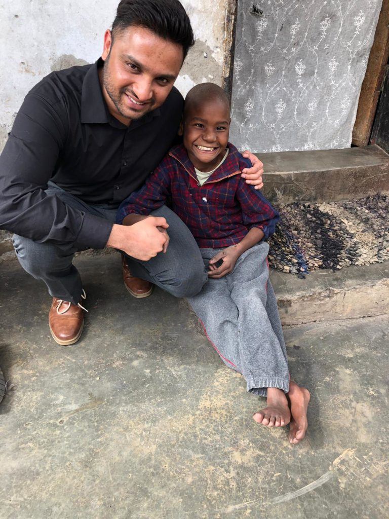 Raskeh, St. Kate student, meets with beneficiaries in Zambia. Here he is with a young Zambian boy who suffers from a physical and intellectual disability. This is the population that Rakesh is working with through the GHR/CMMB Kusamala+ program. 
