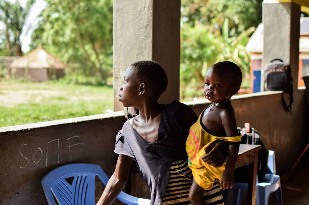 A young woman and baby at a CMMB child protection site