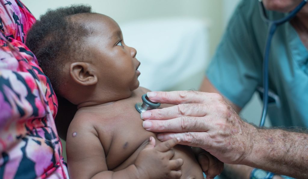 doctor examines baby