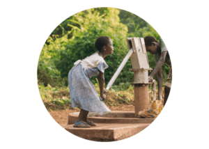 A young girl in South Sudan is working hard to collect water from a wall.