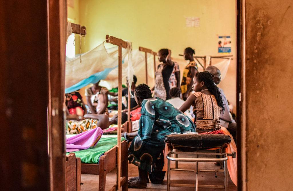 A look through the door of the women's ward at St. Therese hospital. The image is bright and colorful