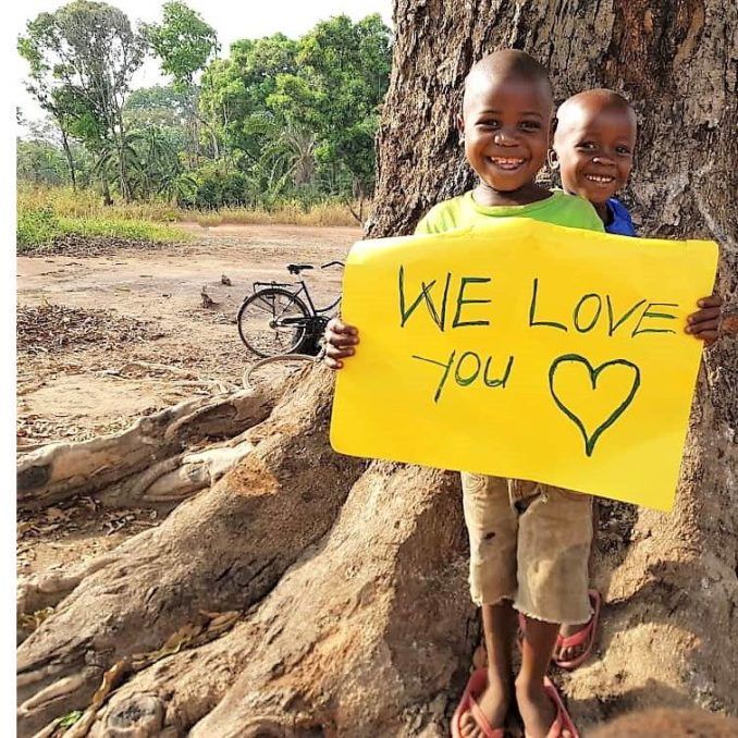 Kenya boy with love you sign