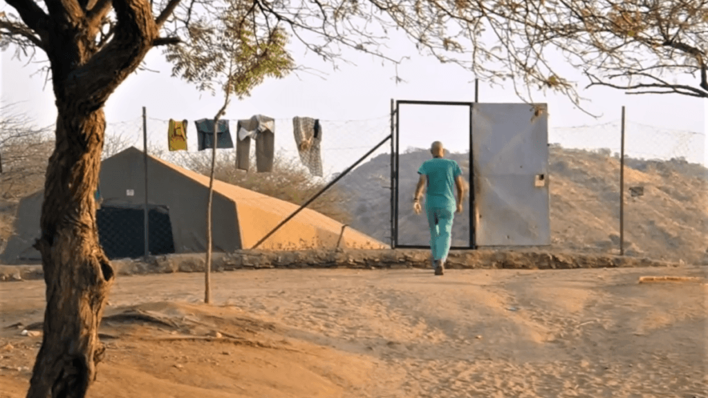 dr tom walking to leprosy village in Sudan
