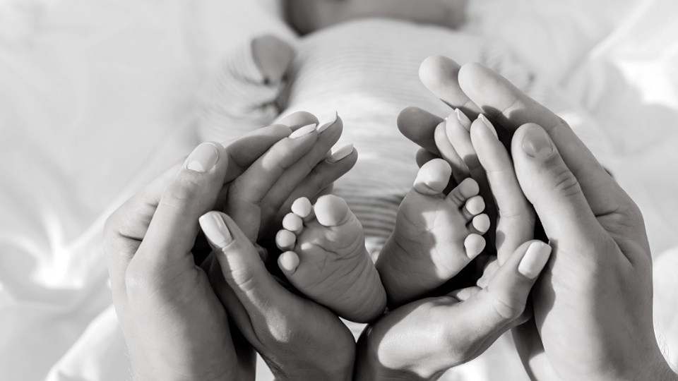 parents holding a baby's feet