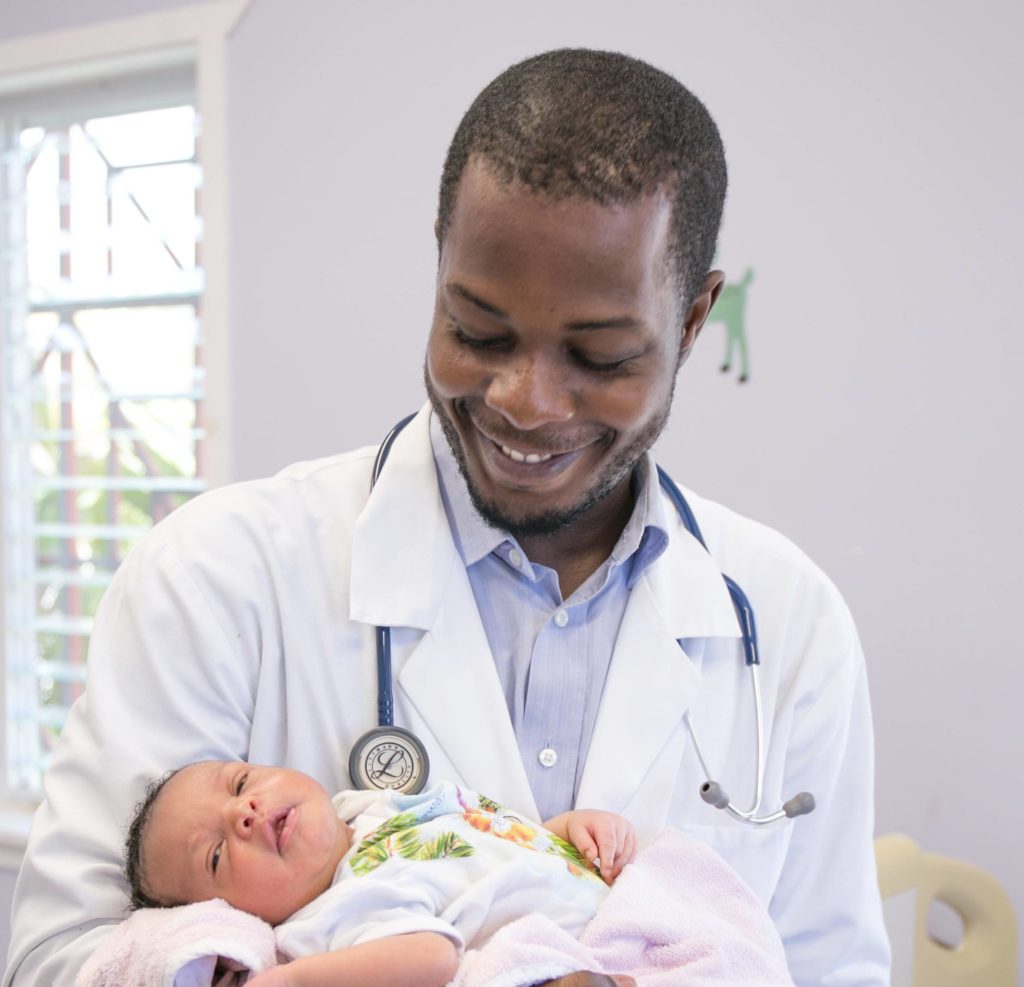 Dr. Lamour with a baby delivered at BJSH