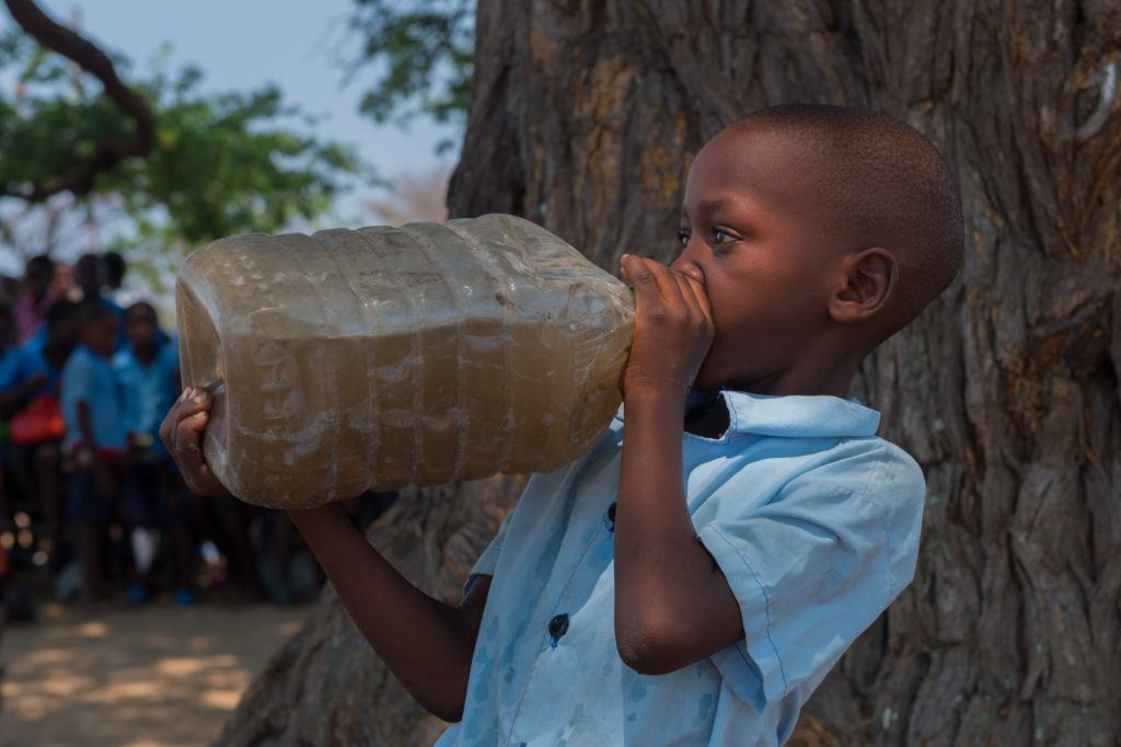 child drinking dirty water