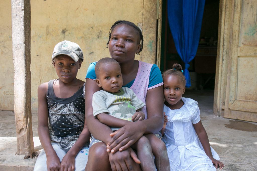 A mother sits with her family in Haiti. At CMMB we are celebrating Mother's Day