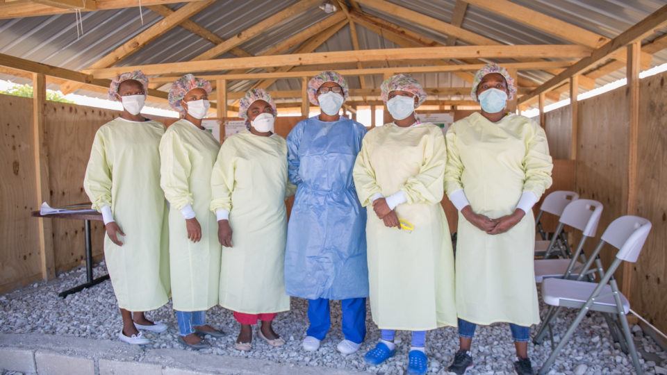 Frontline healthcare workers stand together in Haiti. They are part of our response efforts