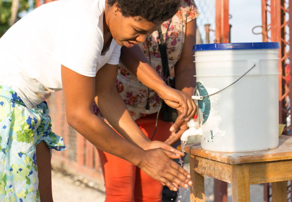 A woman washes her hands to stop the spread of Covid-19