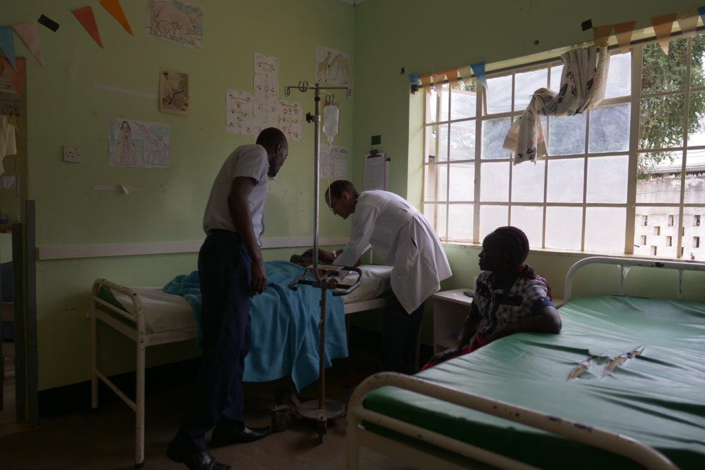 Jose serves a patient at the Mutomo Mission Hospital