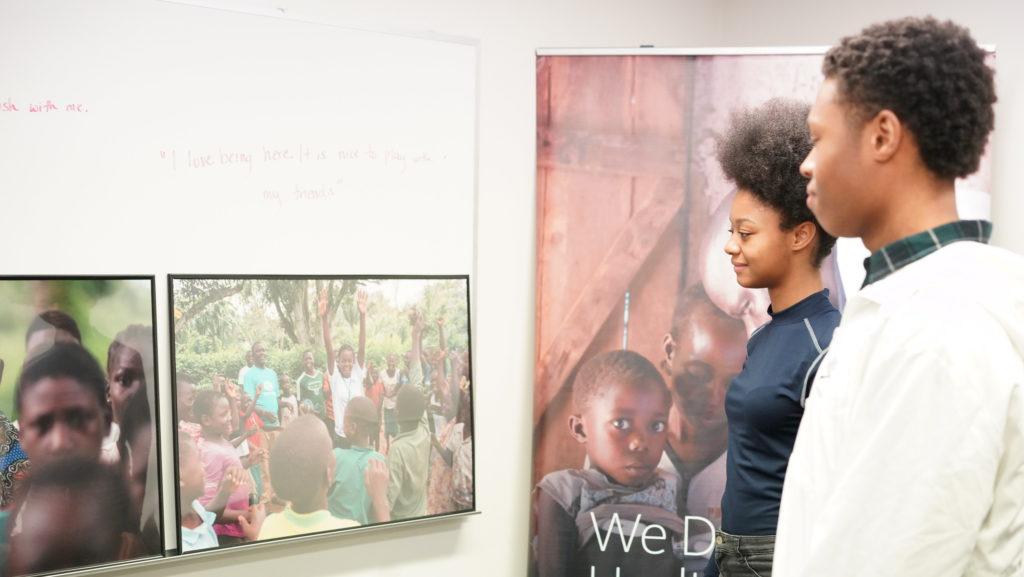 students looking images from child soldier exhibition