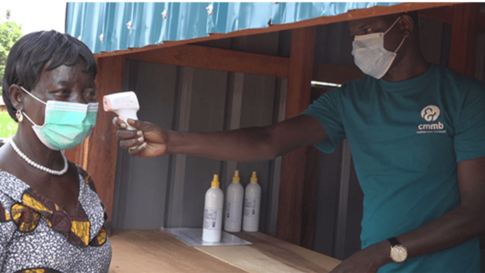 A woman gets her temperature taken in Kenya