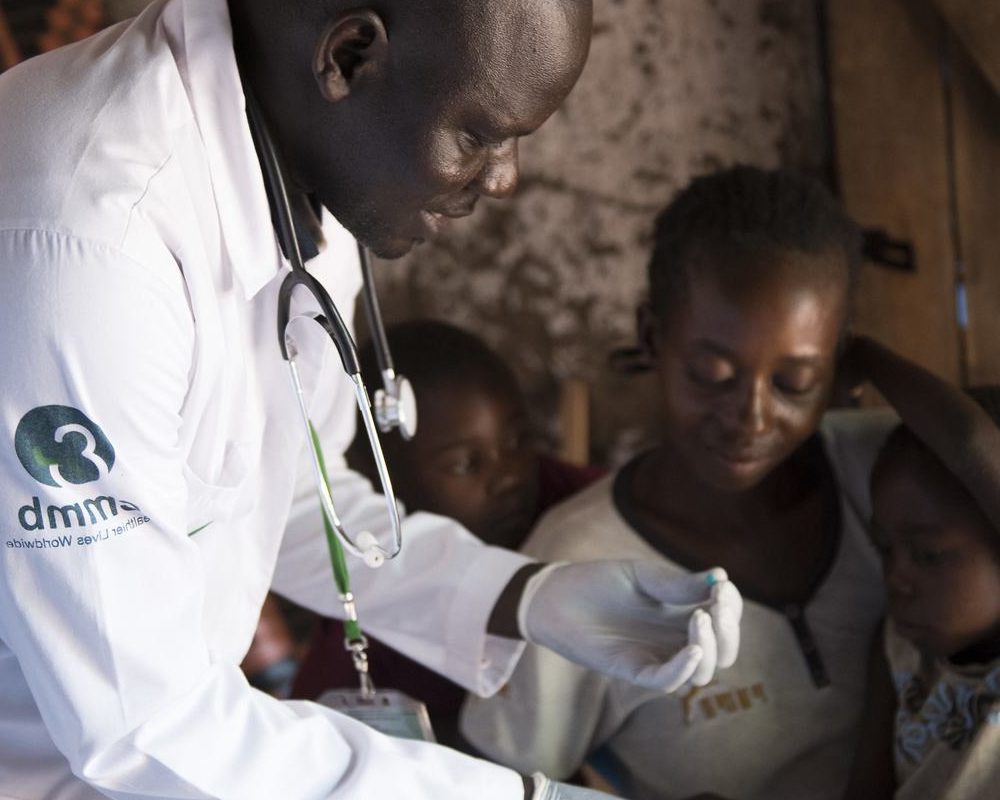 Dr. Alfred Silvesto Okello conducting a malaria test for a child being held by his mother in South Sudan in Septemebr 2017