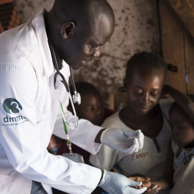 Dr. Alfred Silvesto Okello conducting a malaria test for a child being held by his mother in South Sudan in Septemebr 2017