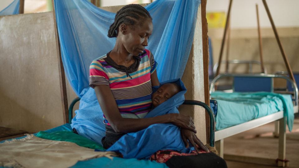 a mother and child in sit in a hospital