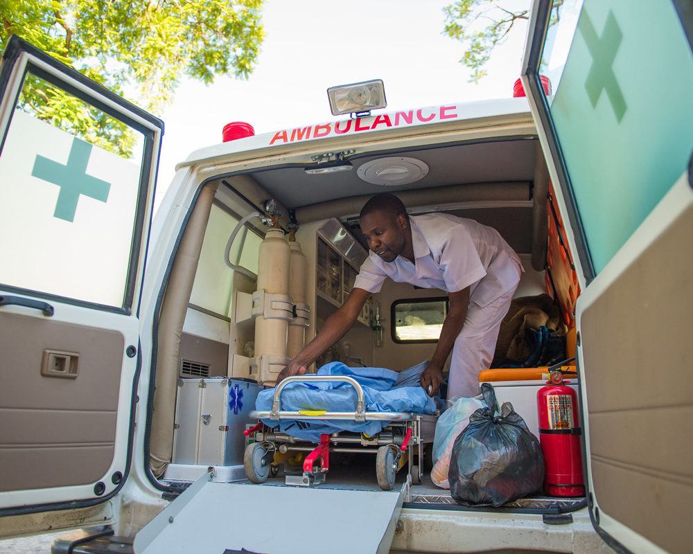 A first responder health care worker removes a stetcher from an ambulance in Zambai in December 2015