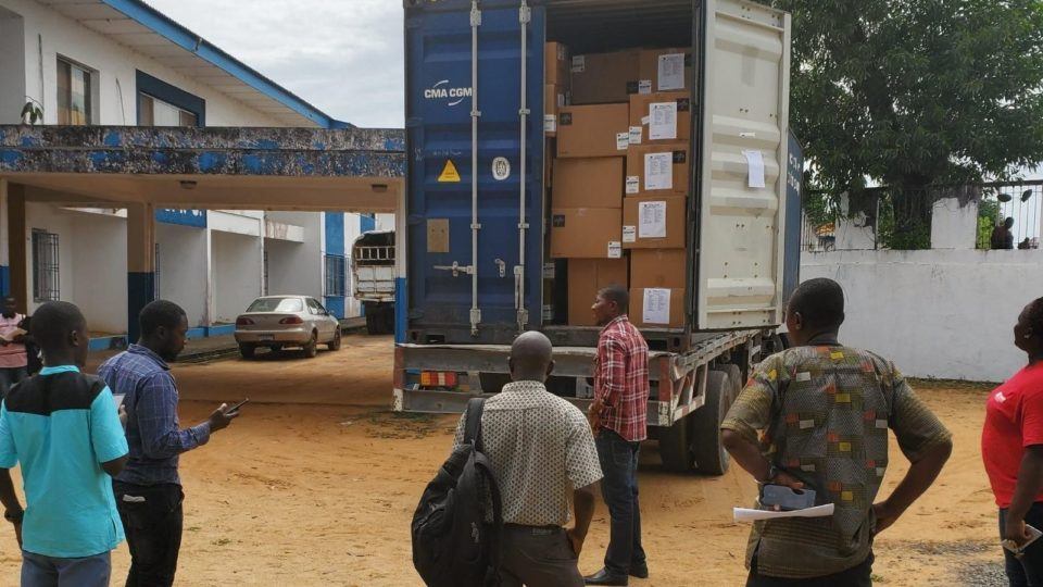 Volunteers unpack medical donations from a truck shipped in Liberia in March 2020