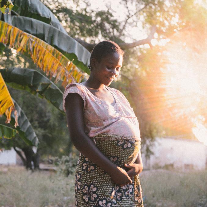 A pregnant woman holding her stomach at Mwandi Mission Hospital in Zambia in June 2018.